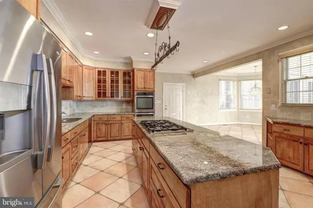 a kitchen with a stove sink and cabinets