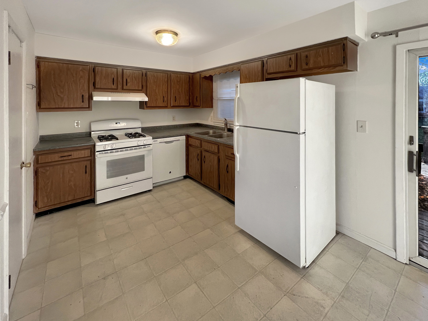 1815 Beach Road McHenry, IL 60050 - Photo 5 of 12 a kitchen with cabinets and white stainless steel appliances