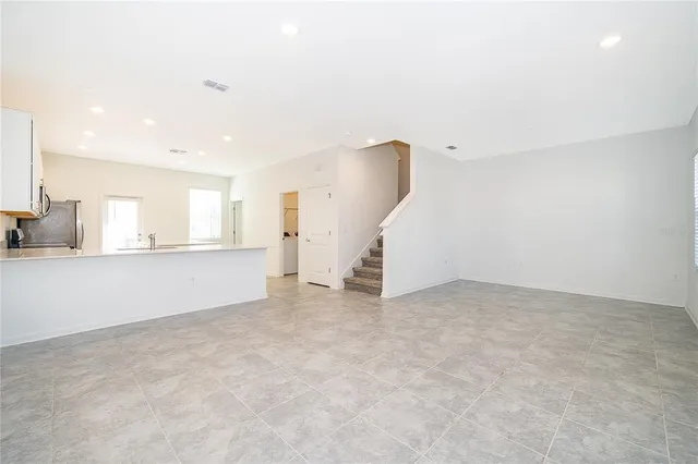 an empty room with a kitchen and a sink