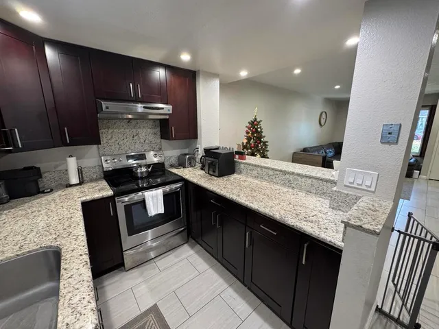 a kitchen with a sink stove and refrigerator