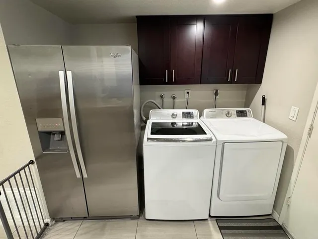 a view of storage and utility room with washer and dryer