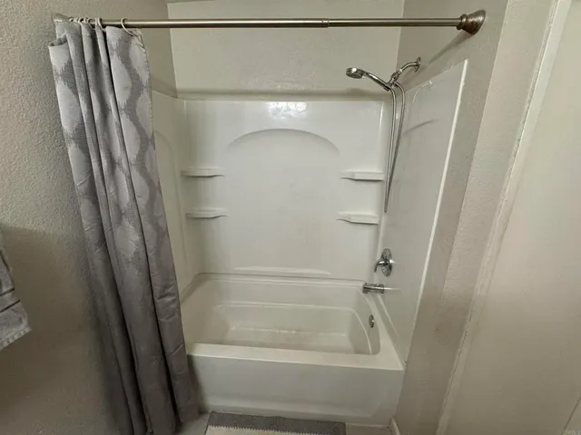 a bathroom with a glass shower door