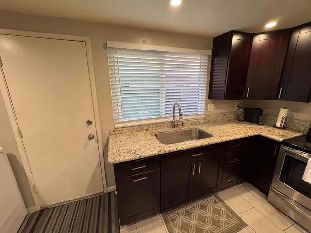 a kitchen with a sink and a stove