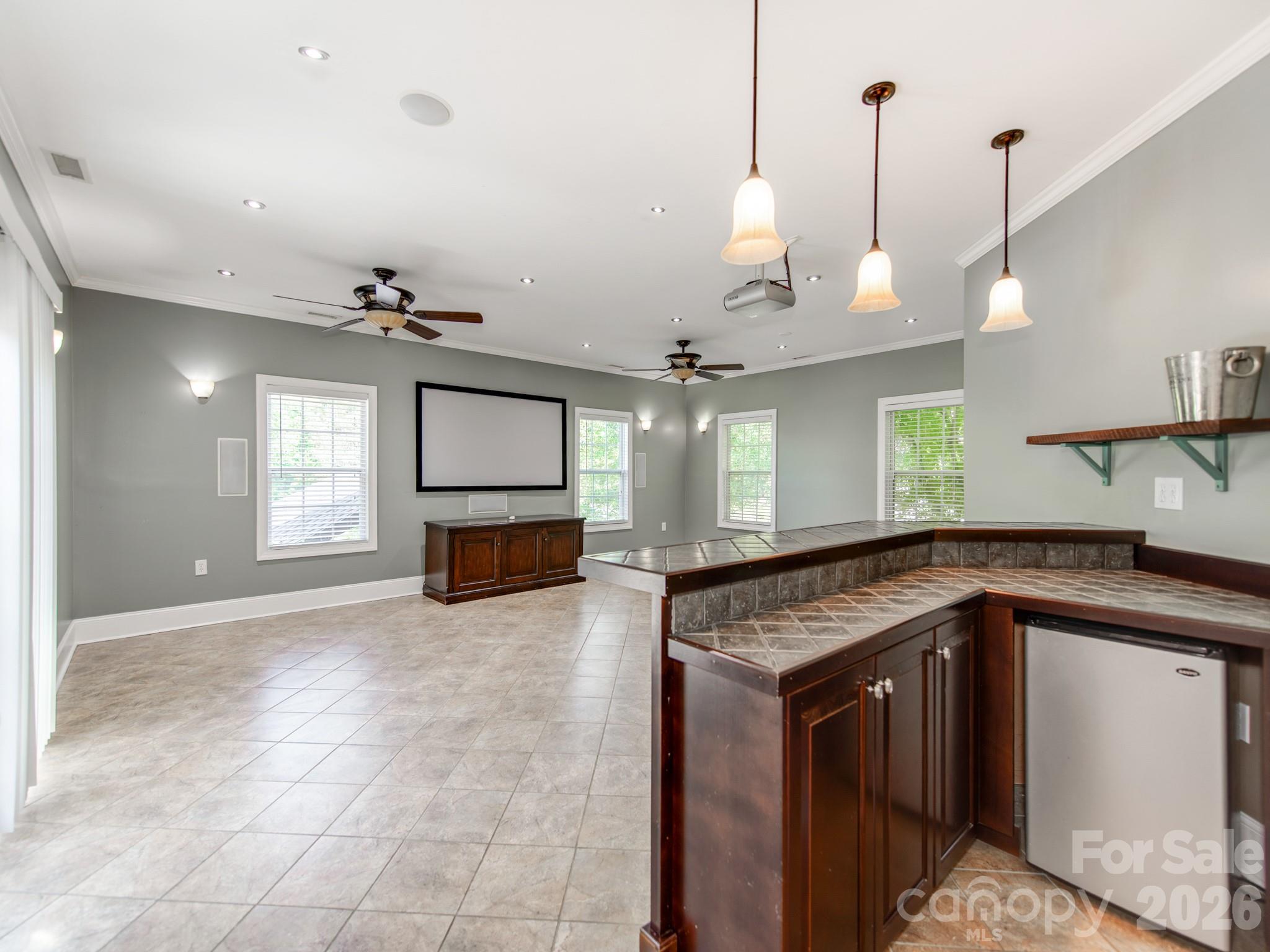 783 Sloan Street Denver, NC 28037 - Photo 11 of 44 a kitchen with kitchen island granite countertop a sink a counter top space appliances and cabinets