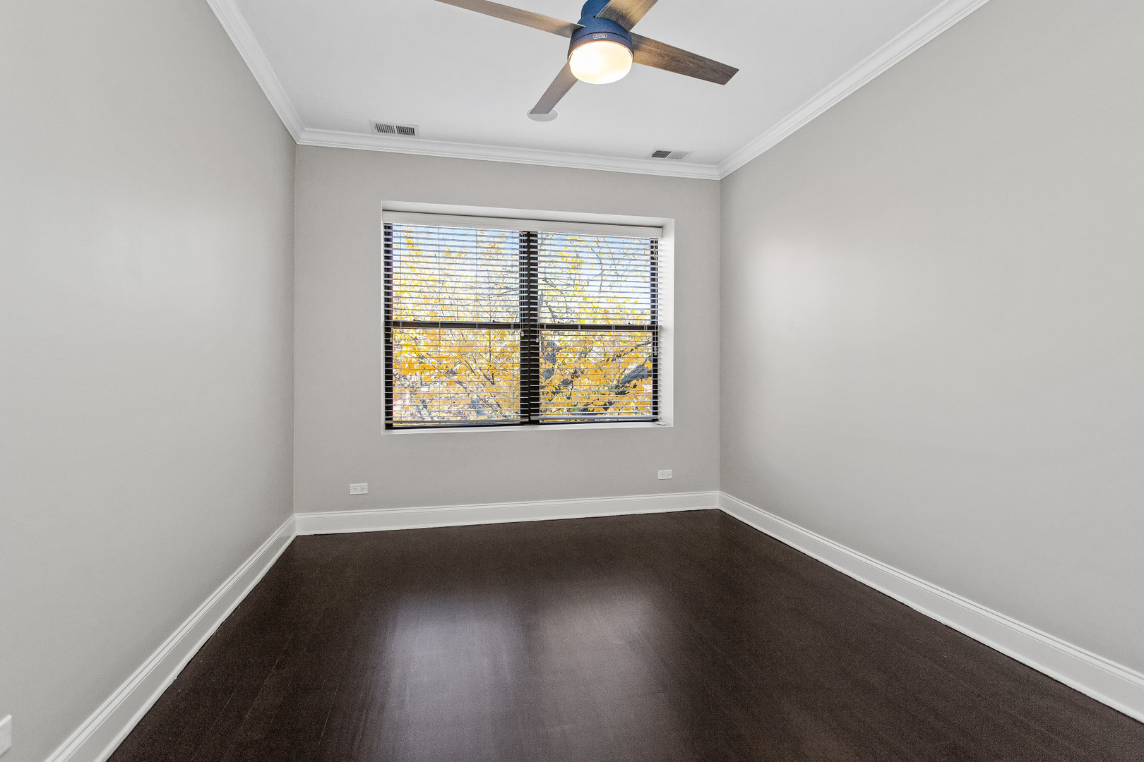 4444 North Damen Avenue, Unit 4E Chicago, IL 60625 - Photo 11 of 25 an empty room with wooden floor fan and windows