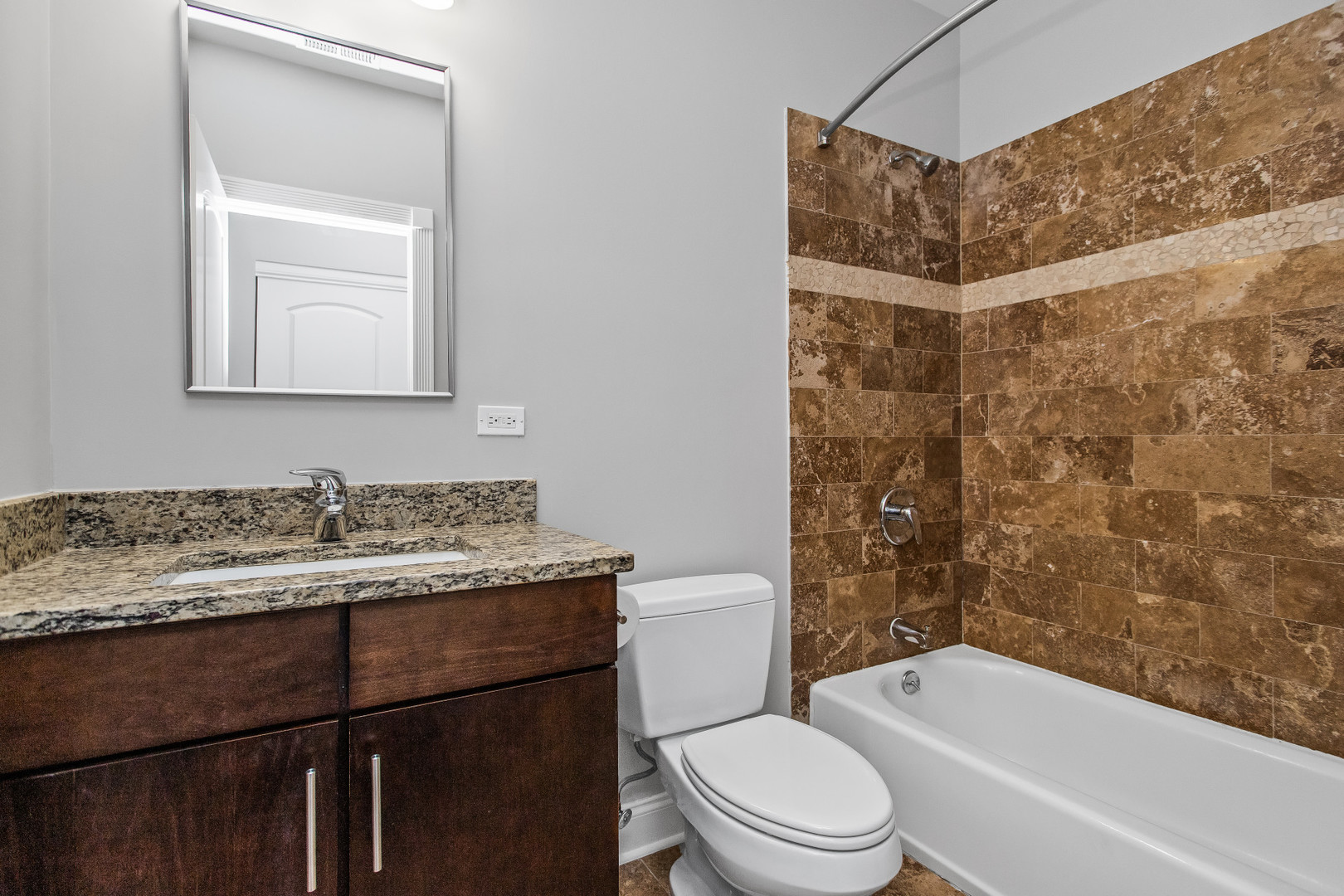 4444 North Damen Avenue, Unit 4E Chicago, IL 60625 - Photo 14 of 25 a bathroom with a granite countertop sink toilet and shower