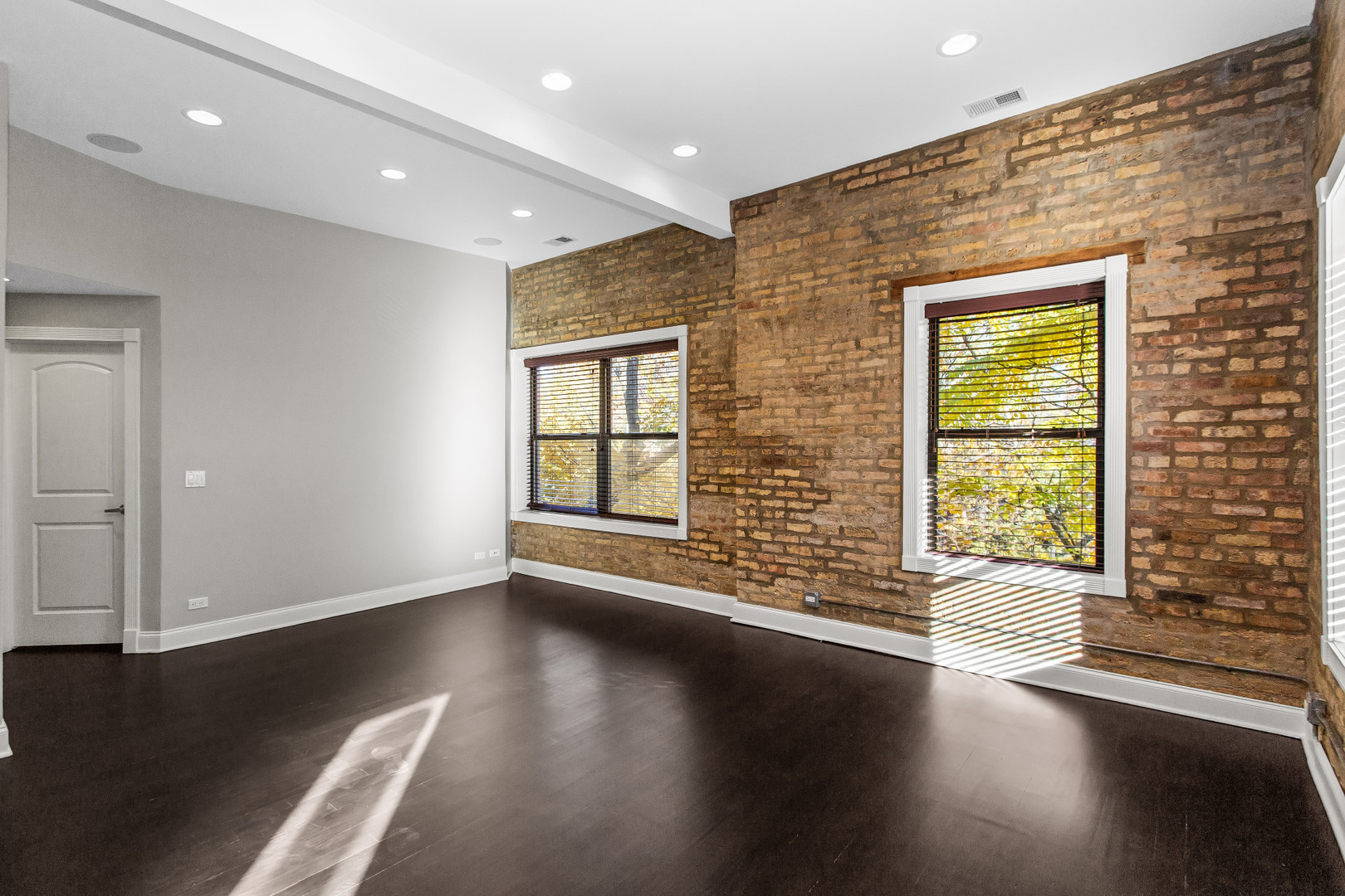 4444 North Damen Avenue, Unit 4E Chicago, IL 60625 - Photo 5 of 25 a view of an empty room with wooden floor and a window