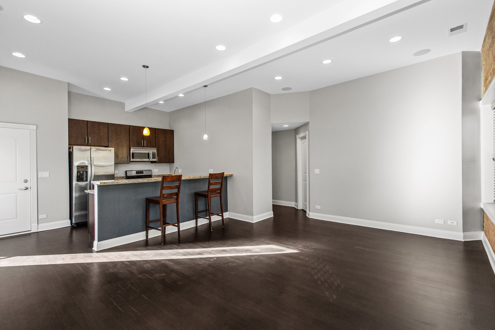 4444 North Damen Avenue, Unit 4E Chicago, IL 60625 - Photo 7 of 25 a view of a kitchen with refrigerator and wooden floor