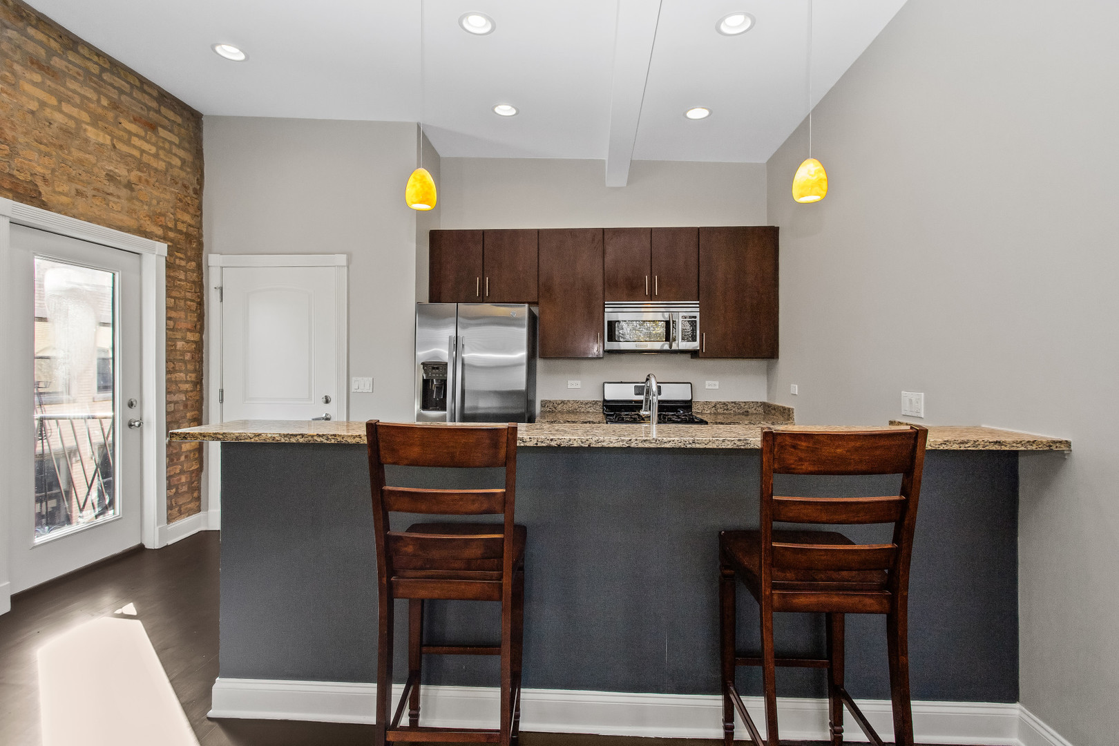 4444 North Damen Avenue, Unit 4E Chicago, IL 60625 - Photo 8 of 25 a kitchen with a refrigerator and furniture