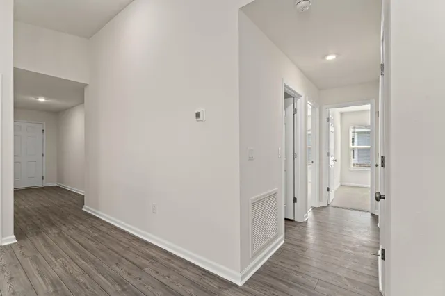a view of a hallway with wooden floor