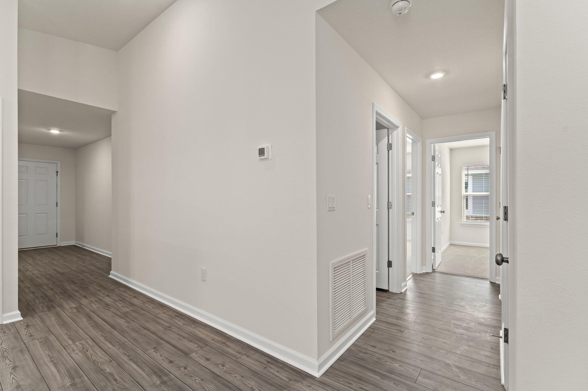 794 Riverwalk Circle Freeport, FL 32439 - Photo 11 of 31 a view of a hallway with wooden floor