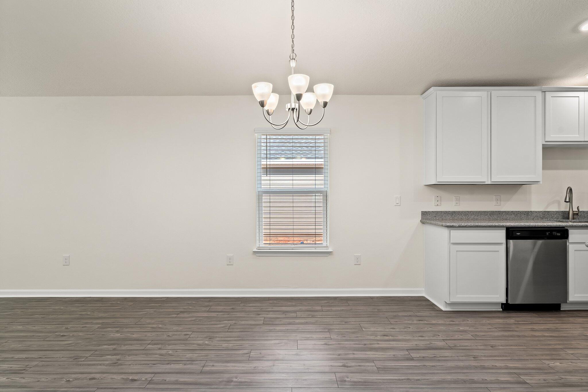 794 Riverwalk Circle Freeport, FL 32439 - Photo 19 of 31 a view of an empty room with wooden floor and a window