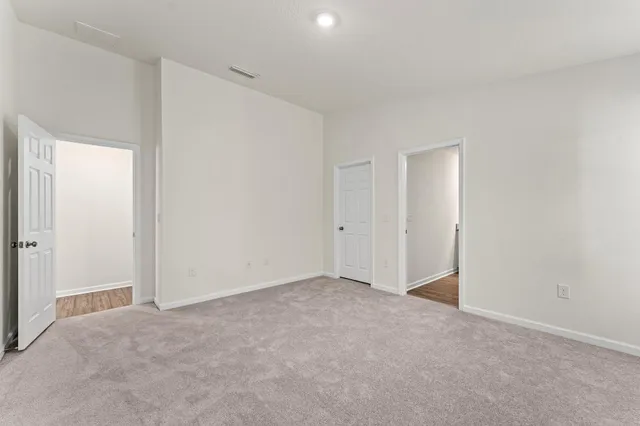 a view of an empty room and entryway