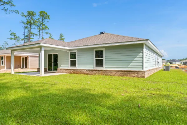 a view of a house with a backyard