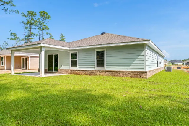 a view of a house with a backyard