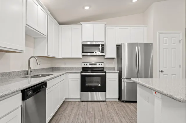 a kitchen with a sink cabinets and stainless steel appliances