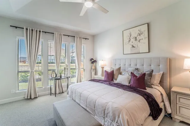 a spacious bedroom with a large bed and a large window