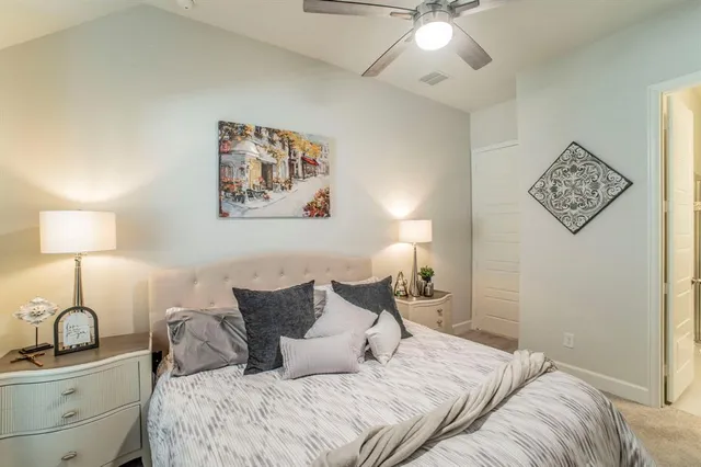 a bedroom with a bed and lamp