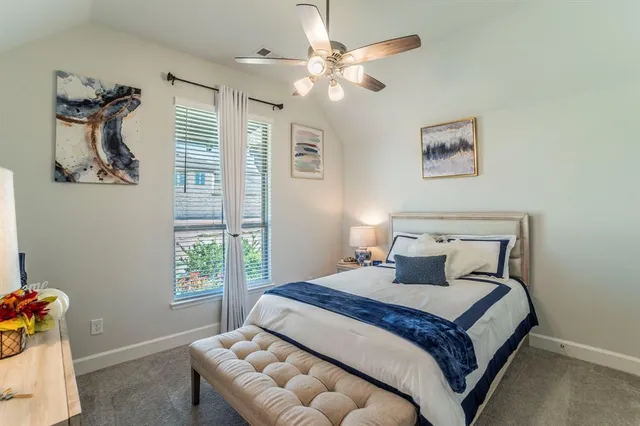 a bedroom with a large bed and a window