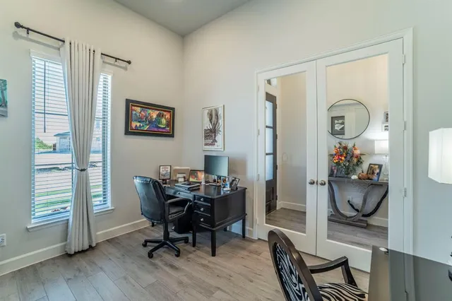 a view of a workspace with furniture and a window
