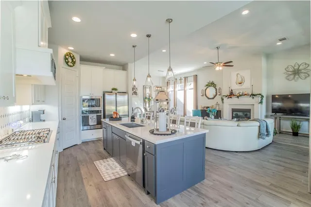 a large kitchen with stainless steel appliances lots of counter top space