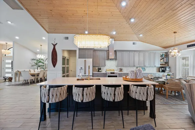 a large kitchen with a table and chairs