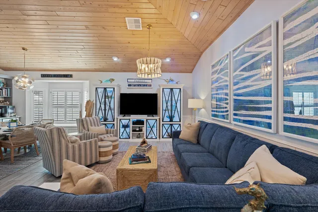 a living room with furniture a flat screen tv and a large window