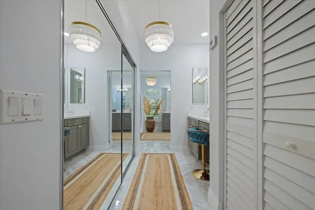 a view of a hallway with wooden floor and a kitchen space