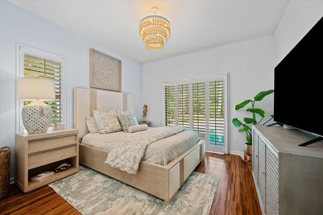 a bedroom with a bed and a flat tv screen on dresser