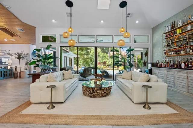 a living room with furniture a rug and a chandelier