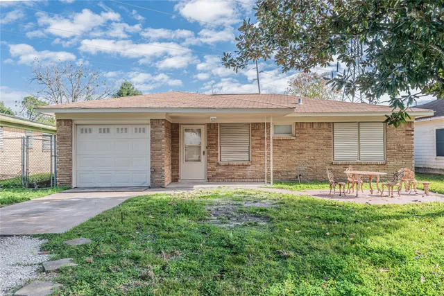 a view of a house with a yard and sitting area