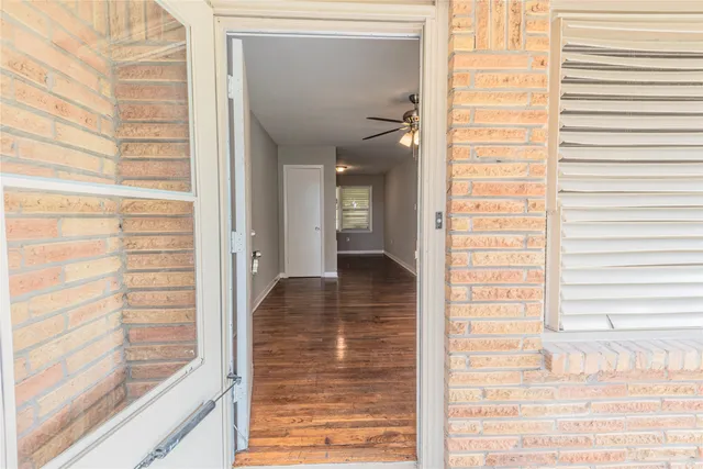 a view of a hallway with a glass door and the window