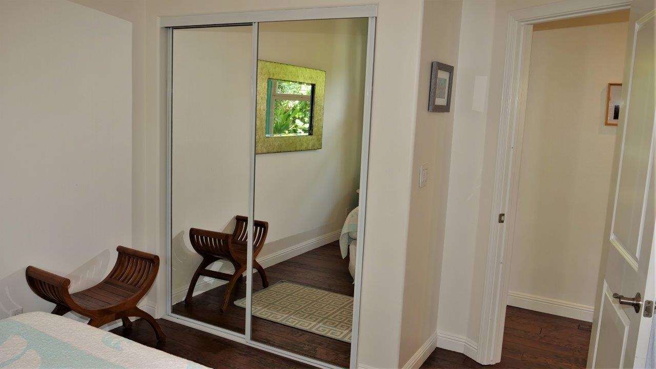 47 Hale Lio Place Haiku, HI 96708 - Photo 16 of 25 a room with a mirror and a wooden floor