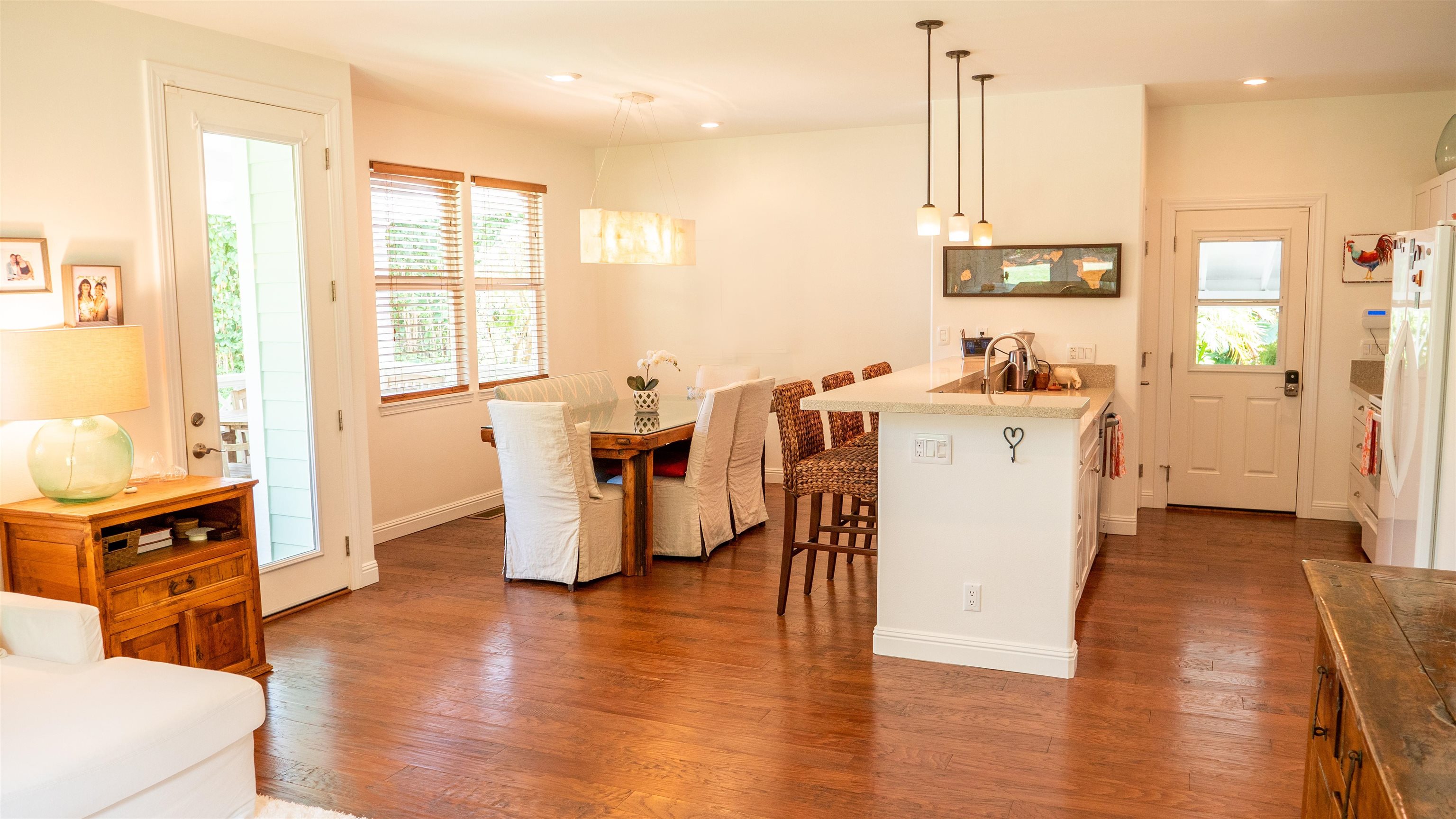 47 Hale Lio Place Haiku, HI 96708 - Photo 6 of 25 a kitchen with stainless steel appliances a stove a sink a refrigerator wooden floor cabinets and dining table