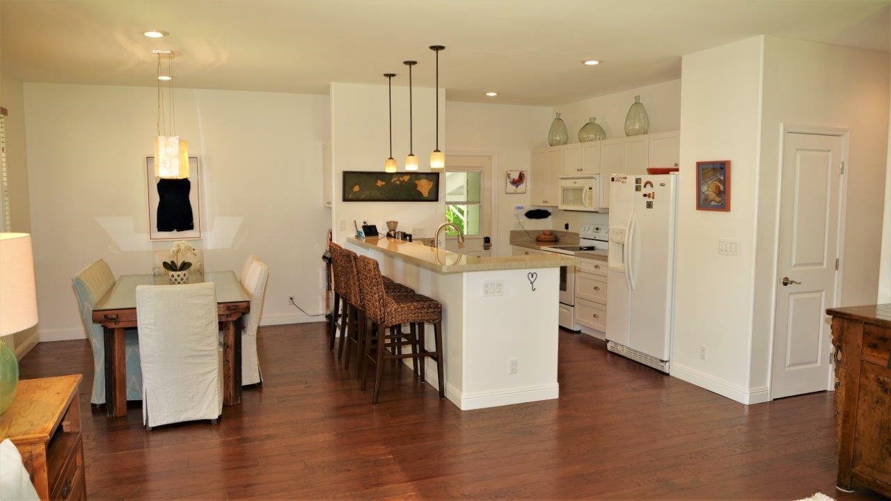 47 Hale Lio Place Haiku, HI 96708 - Photo 7 of 25 a kitchen with stainless steel appliances kitchen island granite countertop a table chairs and a refrigerator