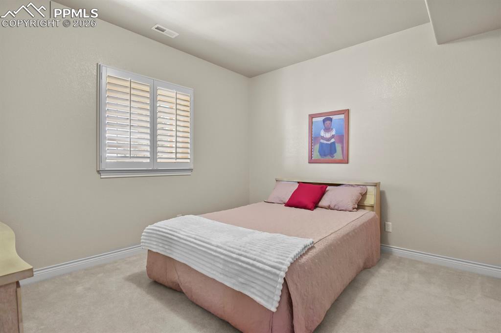617 Concerto Drive Colorado Springs, CO 80906 - Photo 31 of 46 Third bedroom features a window with white plantation shutters and carpeting