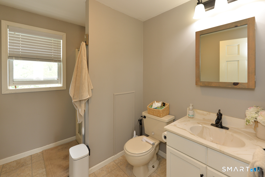 109 Harrison Lane Bethlehem, CT 06751 - Photo 19 of 28 a bathroom with a sink a toilet and a window