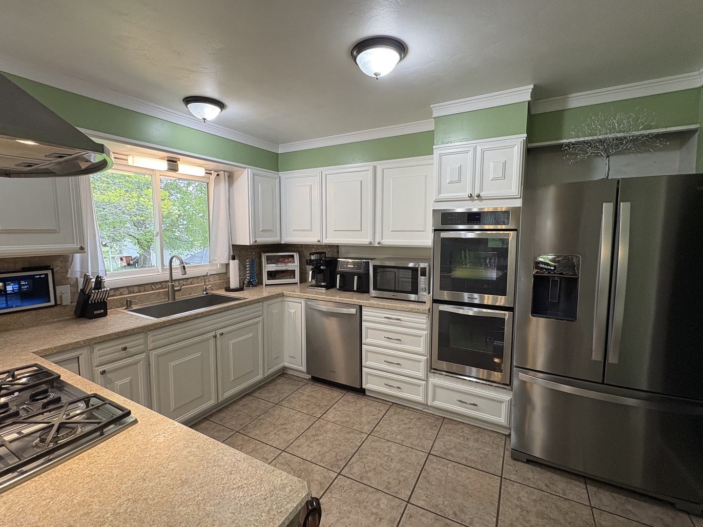 320 South Main Street Creston, IL 61068 - Photo 12 of 34 a kitchen with a stove a sink and a refrigerator