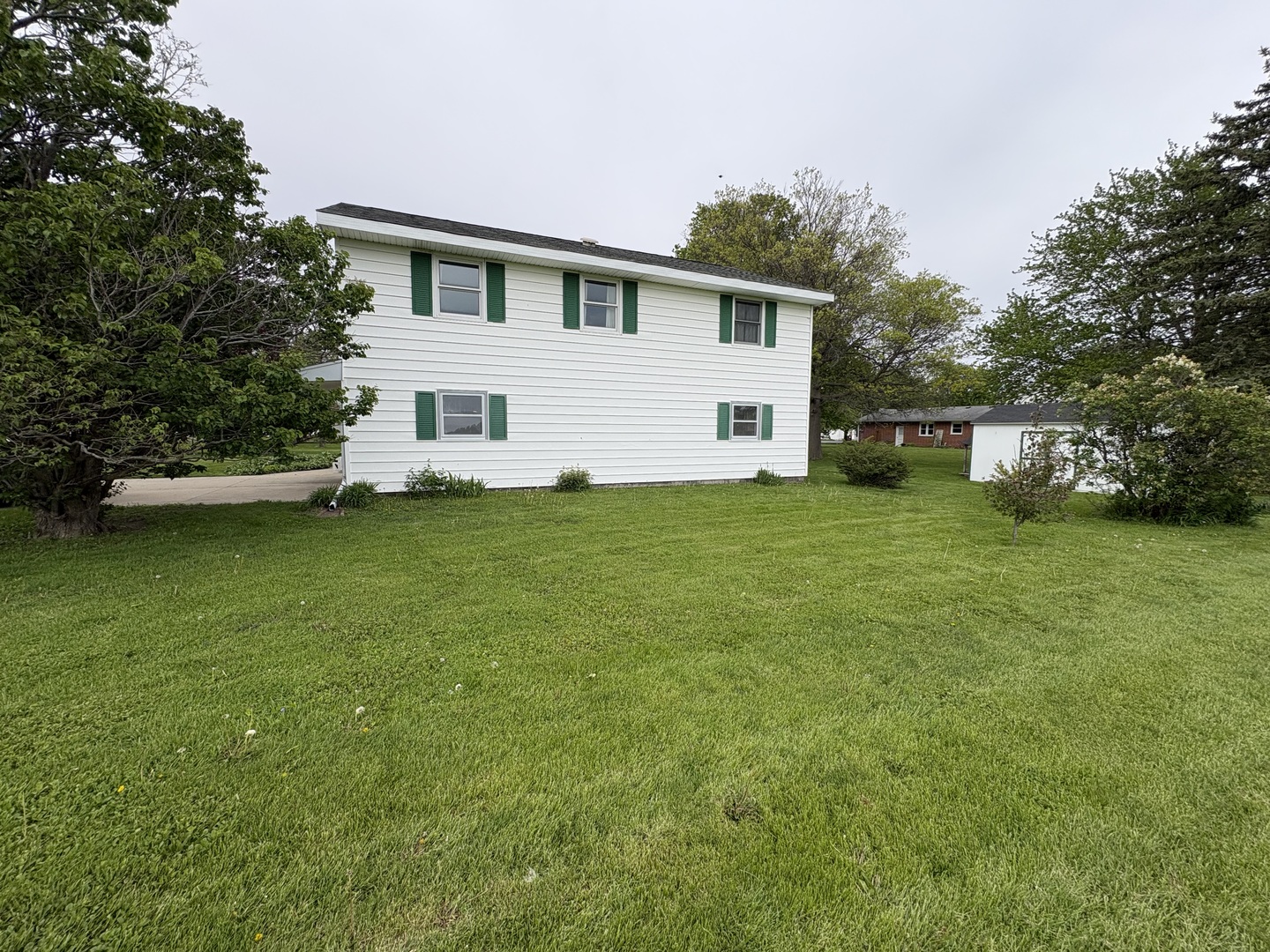 320 South Main Street Creston, IL 61068 - Photo 31 of 34 a view of a house with a yard and sitting area