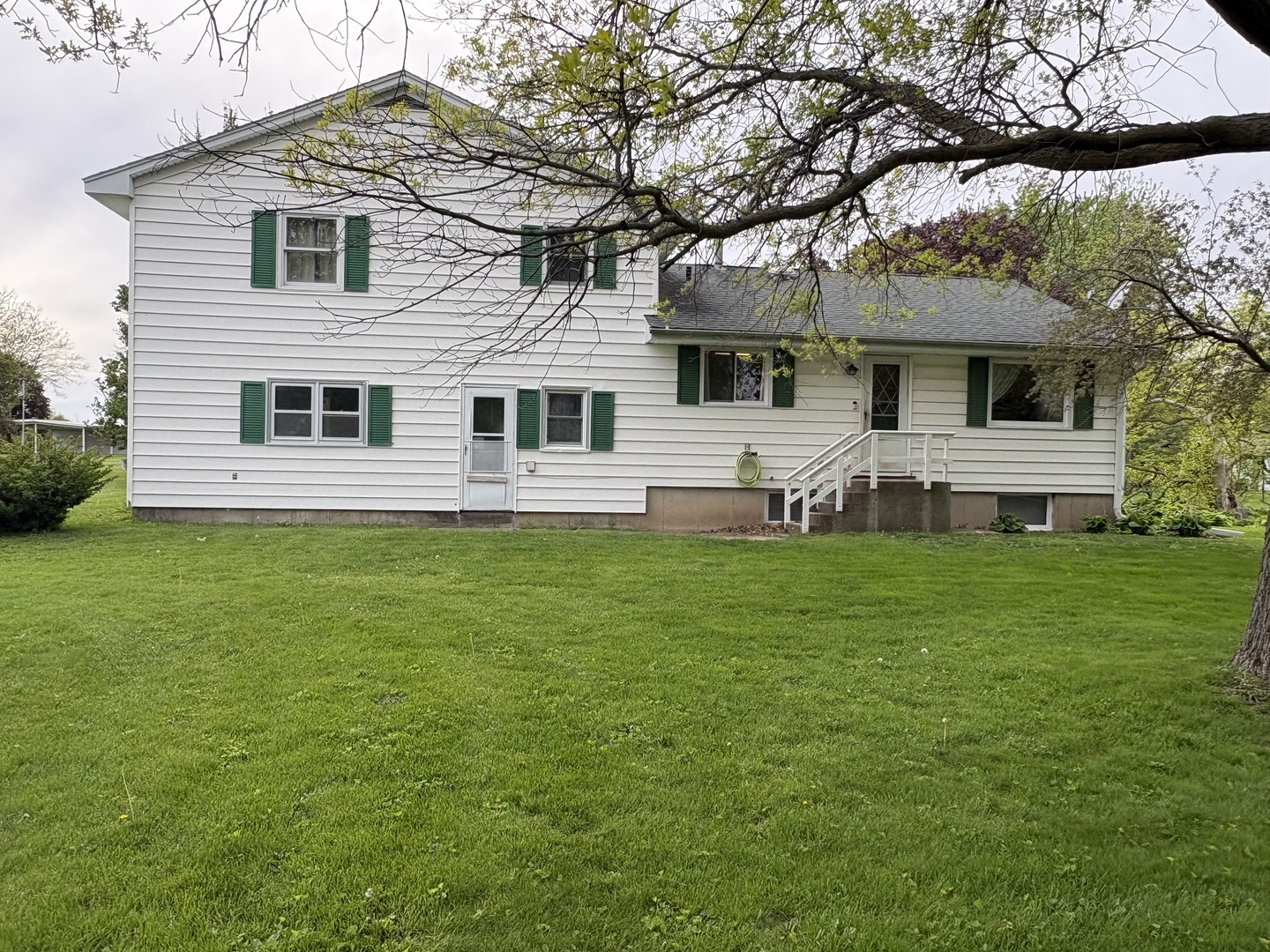 320 South Main Street Creston, IL 61068 - Photo 34 of 34 a front view of a house with a garden and yard