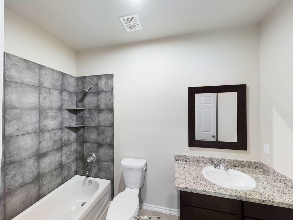 2910 Town Square Avenue, Unit 2607 Bryan, TX 77802 - Photo 6 of 7 a bathroom with a granite countertop sink toilet and shower