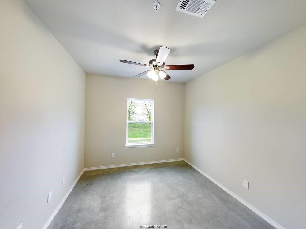 2910 Town Square Avenue, Unit 2607 Bryan, TX 77802 - Photo 7 of 7 an empty room with a window and a ceiling fan