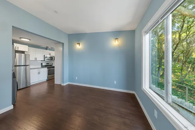 a view of a kitchen with a stove top oven