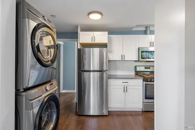a kitchen with stainless steel appliances granite countertop a refrigerator and a stove