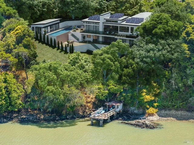 a house with swimming pool in front of it