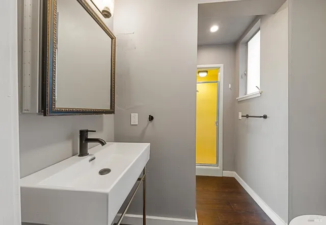 a bathroom with a sink a mirror and a bathtub
