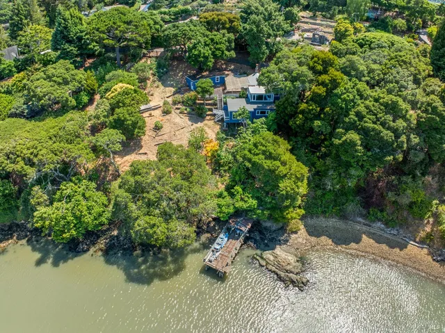 a backyard of a house with a yard and outdoor seating
