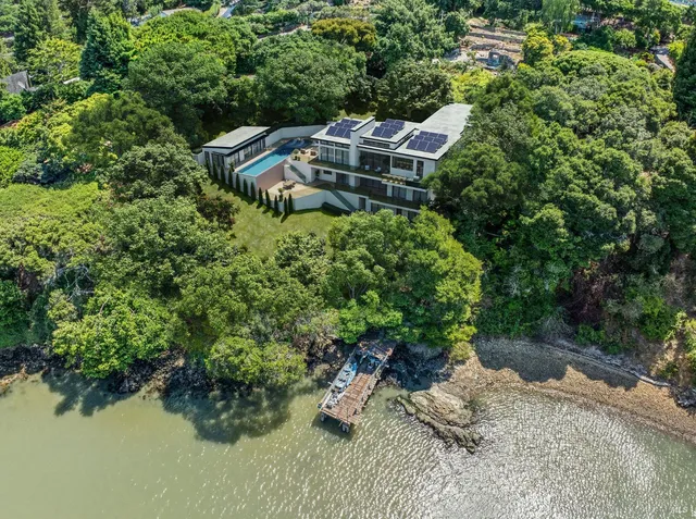 an aerial view of a house with yard and outdoor seating