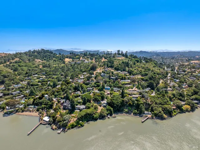 an aerial view of a houses with a street