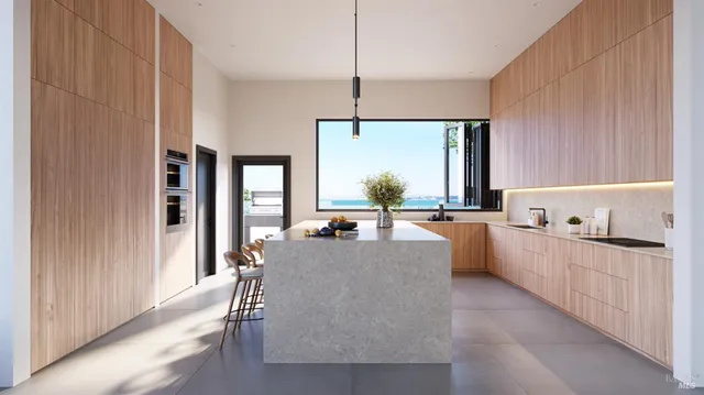 a large kitchen with kitchen island a large counter top space a sink stainless steel appliances and cabinets